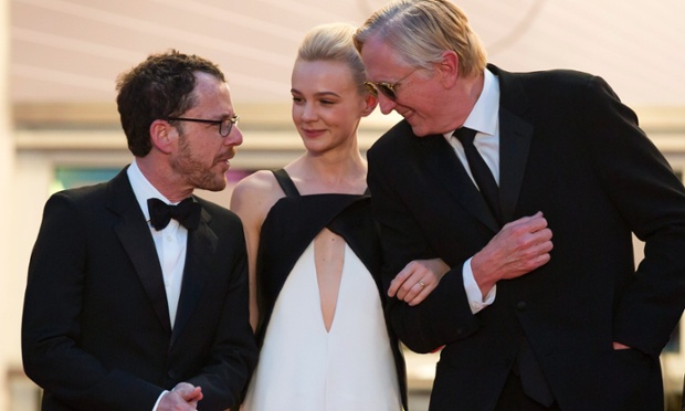 epa03708277 (L-R) US director Ethan Coen, British actress Carey Mulligan and US musician T-Bone Burnett leave the screening of 'Inside Llewyn Davis' during the 66th annual Cannes Film Festival in Cannes, France, 19 May 2013. The movie was presented in the Official Competition of the festival which runs from 15 to 26 May. EPA/IAN LANGSDON