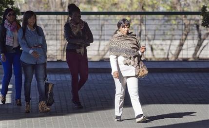 Granddaughter Tukwini Mandela, left, granddaughter Ndileka Mandela, second left, and daughter Makaziwe Mandela, right, arrive at the Mediclinic Heart Hospital where former South African President Nelson Mandela is being treated in Pretoria, South Africa Friday, June 28, 2013. One of the former president's daughters said he is still opening his eyes and reacting to the touch of his family even though his situation is precarious. Woman at second right is unidentified. (AP Photo/Ben Curtis)