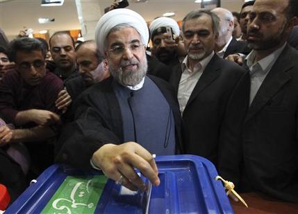 Iranian presidential candidate Hasan Rowhani, a former Iran's top nuclear negotiator, casts his ballot during presidential elections at a polling station in downtown Tehran, Iran, Friday, June 14, 2013. (AP Photo/Vahid Salemi)