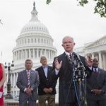 Jenny Beth Martin, co-founder of the Tea Party Patriots, listens at left, as Sen. Jeff Sessions, R-Ala., speaks at a news conference hosted by the Tea Party Patriots to oppose the Senate immigration reform bill, Thursday, June 20, 2013, on Capitol Hill in Washington. From left are, Martin; Akady Faktorovich, an immigrant from the former Soviet Union; Hans Marsen, an immigrant from England; Sessions; Niger Innis with TheTeaParty.Net, and George Wilkerson with The Remembrance Project. White House-backed immigration legislation gained momentum in the Senate on Thursday as lawmakers closed in on a bipartisan compromise to spend tens of billions of dollars stiffening border security without delaying legalization for millions living in the country unlawfully. (AP Photo/Jacquelyn Martin)