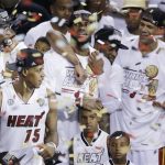 Miami Heat players including LeBron James, top center, celebrate after Game 7 of the NBA basketball championship game against the San Antonio Spurs, Friday, June 21, 2013, in Miami. The Miami Heat defeated the San Antonio Spurs 95-88 to win their second straight NBA championship. (AP Photo/Wilfredo Lee)