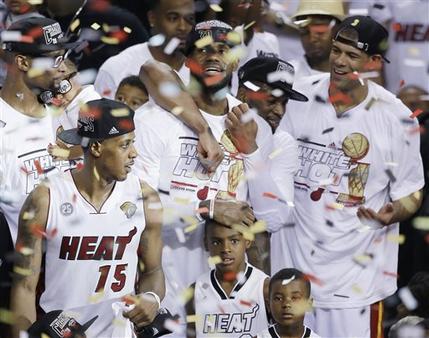 Miami Heat players including LeBron James, top center, celebrate after Game 7 of the NBA basketball championship game against the San Antonio Spurs, Friday, June 21, 2013, in Miami. The Miami Heat defeated the San Antonio Spurs 95-88 to win their second straight NBA championship. (AP Photo/Wilfredo Lee)