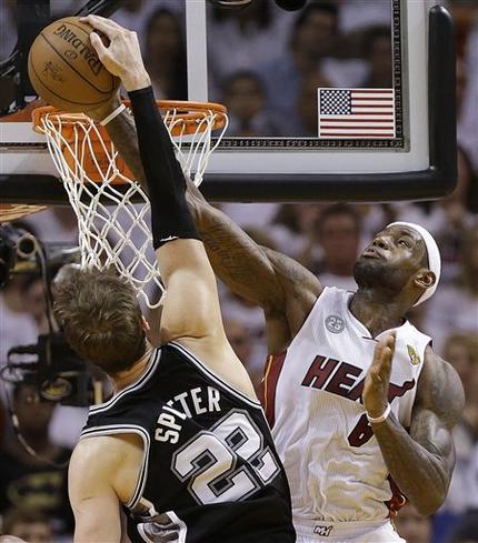 Miami Heat small forward LeBron James (6) blocks a shot by San Antonio Spurs center Tiago Splitter (22) of Brazil, during the second half of Game 2 of the NBA Finals basketball game, Sunday, June 9, 2013 in Miami. The Miami Heat won 103-84. (AP Photo/Lynne Sladky)