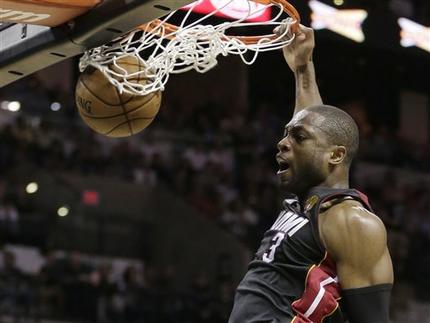 Miami Heat's Dwyane Wade (3) dunks against the San Antonio Spurs during the second half at Game 4 of the NBA Finals basketball series, Thursday, June 13, 2013, in San Antonio. (AP Photo/Eric Gay)