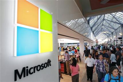 FILE - In this Thursday, Aug. 23, 2012 file photo, the Microsoft Corp. logo, left, is seen on an exterior wall of a new Microsoft store inside the Prudential Center mall, in Boston. Microsoft will use its annual developers conference to release a preview of Windows 8.1, a free update that promises to address some of the gripes people have with the latest version of the companys flagship operating system. The Build conference, which starts Wednesday, June 26, 2013, in San Francisco, will give Microsofts partners and other technology developers a chance to try out the new system before it becomes available to the general public later in the year. (AP Photo/Steven Senne, File)