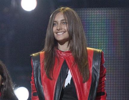 FILE - In this Oct. 8, 2011 file photo Paris Jackson smiles on stage at the Michael Forever the Tribute Concert, at the Millennium Stadium in Cardiff, Wales. Jackson is physically fine after being taken to a hospital early Wednesday, June 5, 2013, an attorney for Jackson's mother said. Perry Sanders Jr. writes in a statement that Paris Jackson is getting appropriate medical attention and the family is seeking privacy. Fire and sheriff's officials confirmed they transported someone from a home in Paris' suburban Calabasas neighborhood for a possible overdose but did not release any identifying information or additional details. (AP Photo/Joel Ryan, File)