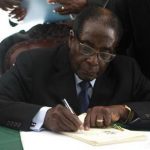 Zimbabwe President Robert Mugabe signs Zimbabwe's new constitution into law in the capital Harare, replacing a 33-year-old document forged in the dying days of British colonial rule and paving the way for elections later this year, May 22, 2013. REUTERS/Philimon Bulawayo
