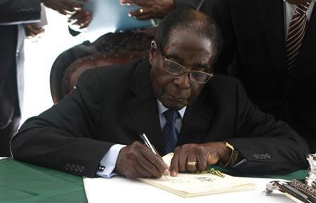 Zimbabwe President Robert Mugabe signs Zimbabwe's new constitution into law in the capital Harare, replacing a 33-year-old document forged in the dying days of British colonial rule and paving the way for elections later this year, May 22, 2013. REUTERS/Philimon Bulawayo