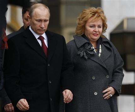 FILE - In this Sunday, March 4, 2012 file photo then Russian Prime Minister and presidential candidate Vladimir Putin and his wife Lyudmila leave a polling station in Moscow, Russia.  Russian President Vladimir Putin and his wife Lyudmila have announced they are divorcing.  Married just a few weeks short of 30 years, the Putins announced the decision on state television after attending a ballet performance Thursday evening in the Kremlin.( AP Photo/Alexander Zemlianichenko, file)