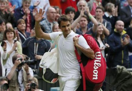 Roger Federer of Switzerland walks off the court after being defeated by Sergiy Stakhovsky of Ukraine in their men's singles tennis match at the Wimbledon Tennis Championships, in London June 26, 2013. REUTERS/Stefan Wermuth