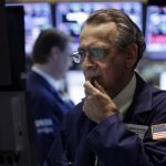 Specialist Joseph Quaglieri looks at a monitor as he works on the floor of the New York Stock Exchange, Thursday, June 20, 2013. Financial markets are sliding after the Federal Reserve said it could end its huge bond-buying program by the middle of next year. (AP Photo/Richard Drew)