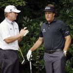Steve Stricker, left, and Phil Mickelson talk before teeing off on the 11th hole during the first round of the U.S. Open golf tournament at Merion Golf Club, Thursday, June 13, 2013, in Ardmore, Pa. (AP Photo/Morry Gash)