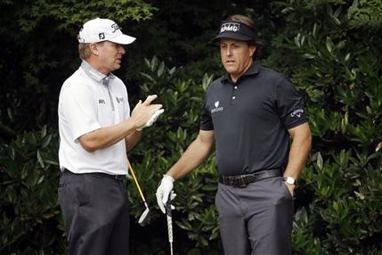 Steve Stricker, left, and Phil Mickelson talk before teeing off on the 11th hole during the first round of the U.S. Open golf tournament at Merion Golf Club, Thursday, June 13, 2013, in Ardmore, Pa. (AP Photo/Morry Gash)