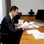 This photo released on the official Facebook page of Syrian President Bashar Assad, shows Syrian president Bashar Assad working in his office, in Damascus, Syria, Thursday, June 13, 2013. State TV quoted Transpiration Minister as saying that a mortar round fell on the edge of the airport delaying two flights that were going to land one from Latakia and one from Kuwait. The attack also delayed the take off of a Syrian flight to Baghdad. None of the planes or there passengers were hit. (AP Photo)