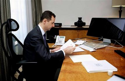 This photo released on the official Facebook page of Syrian President Bashar Assad, shows Syrian president Bashar Assad working in his office, in Damascus, Syria, Thursday, June 13, 2013. State TV quoted Transpiration Minister as saying that a mortar round fell on the edge of the airport delaying two flights that were going to land one from Latakia and one from Kuwait. The attack also delayed the take off of a Syrian flight to Baghdad. None of the planes or there passengers were hit. (AP Photo)