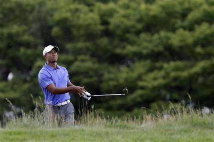 Tiger Woods watches his shot on the first hole during the first round of the U.S. Open golf tournament at Merion Golf Club, Thursday, June 13, 2013, in Ardmore, Pa. (AP Photo/Gene J. Puskar)