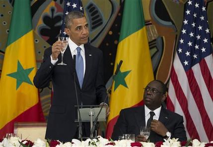 U.S. President Barack Obama, left, makes a toast during an official dinner with Senegalese President Macky Sall at the Presidential Palace on Thursday, June 27, 2013, in Dakar, Senegal. Obama is visiting Senegal, South Africa, and Tanzania on a week long trip. (AP Photo/Evan Vucci)