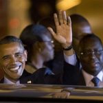 U.S. President Barack Obama, standing beside Senegalese counterpart Macky Sall, waves as he boards a car after arriving at the airport in Dakar, Senegal, Wednesday, June 26, 2013. President Obama opened a weeklong trip to Africa on Wednesday, a three-country visit aimed at overcoming disappointment on the continent over the first black U.S. president's lack of personal engagement during his first term. (AP Photo/Rebecca Blackwell)