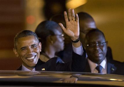U.S. President Barack Obama, standing beside Senegalese counterpart Macky Sall,  waves as he boards a car after arriving at the airport in Dakar, Senegal, Wednesday, June 26, 2013. President Obama opened a weeklong trip to Africa on Wednesday, a three-country visit aimed at overcoming disappointment on the continent over the first black U.S. president's lack of personal engagement during his first term. (AP Photo/Rebecca Blackwell)