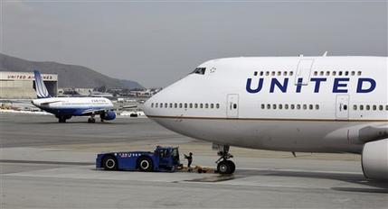 FILE - This Feb. 23, 2011 file photo shows United Airlines planes taxing at San Francisco International Airport in San Francisco. The government is moving toward easing restrictions on the use of electronic devices by airline passengers during taxiing, takeoffs and landings. An industry-labor advisory committee was expected to make recommendations next month to the Federal Aviation Administration on easing the restrictions, but the FAA said Friday that deadline has been extended to September. (AP Photo/Eric Risberg, File)