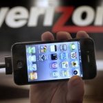 FILE - In this Feb. 10, 2011 file photo, Chris Cioban, manager of the Verizon store in Beachwood, Ohio, holds up an Apple iPhone 4G. Britain's Guardian newspaper says the National Security Agency is currently collecting the telephone records of millions of U.S. customers of Verizon under a secret court order. The newspaper said Wednesday, June 5, 2013 the order was issued in April and was good until July 19. The newspaper said the order requires Verizon on an "ongoing, daily basis" to give the NSA information on all telephone calls in its systems, both within the U.S. and between the U.S. and other countries. (AP Photo/Amy Sancetta, File)