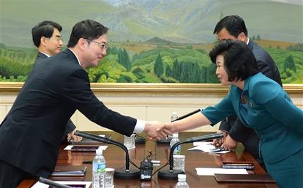 In this photo released by the South Korean Unification Ministry, South Korea's Unification Policy Officer Chun Hae-sung, left, shakes hands with the head of North Korea's delegation Kim Song Hye, right, after ending their meeting at the southern side of Panmunjom, which has separated the two Koreas since the Korean War, in Paju, South Korea, Monday, June 10, 2013. The rival Koreas will hold senior-level talks this week in Seoul, South Korea said Monday, a breakthrough of sorts after Pyongyangs recent threats of nuclear war and Seouls vows of counterstrikes.(AP Photo/South Korean Unification Ministry)