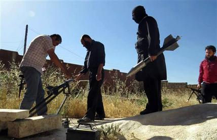 This citizen journalism image provided by Edlib News Network, ENN, which has been authenticated based on its contents and other AP reporting, shows Syrian rebels preparing to fire locally made rockets, in Idlib province, northern Syria, Tuesday, June 4, 2013. The Syrian government has denied it is facing a popular uprising since the revolt against Assad's rule erupted in March 2011, saying that the army is fighting foreign-backed terrorists who want to destroy the country.(AP Photo/Edlib News Network ENN)