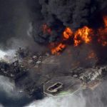 FILE - In this April 21, 2010 file aerial photo, the Deepwater Horizon oil rig burns in the Gulf of Mexico more than 50 miles southeast of Venice, La. A lawyer working for the court-appointed administrator to review claims as part of the multibillion-dollar settlement over BP's Gulf oil spill has been accused of receiving payments from a law firm representing a claimant, allegations that were discussed in a closed-door meeting Thursday, June 20, 2013, with a federal judge overseeing the case, a BP official with direct knowledge of the situation told The Associated Press. (AP Photo/Gerald Herbert, File)