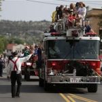 A fire truck carrying friends and family members of the Granite Mountain Interagency Hotshot Crew leads the Prescott Frontier Days Rodeo Parade Saturday, July 6, 2013 in Prescott, Ariz. The firefighters were killed battling a wildfire near Yarnell, Ariz., Sunday, June 30. (AP Photo/Chris Carlson)