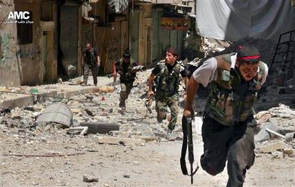 This Tuesday, July 9, 2013 citizen journalism image provided by Aleppo Media Center AMC, which has been authenticated based on its contents and other AP reporting, shows Syrian rebels running during heavy clashes with Syrian soldiers loyal to Syrian President Bashar Assad, in the Salah al-Din neighborhood of Aleppo, Syria. Syria is entering its third year of a war that began as an uprising against the rule of President Bashar Assad. (AP Photo/Aleppo Media Center AMC)