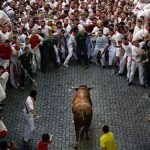 An Alcurrucen's ranch fighting bull runs towards revelers during the running of the bulls of the San Fermin festival, in Pamplona, Spain, Sunday, July 7, 2013. Revelers from around the world arrive to Pamplona every year to take part on some of the eight days of the running of the bulls glorified by Ernest Hemingway's 1926 novel "The Sun Also Rises." (AP Photo/Daniel Ochoa de Olza)