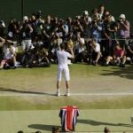 Andy Murray of Britain, center, poses for photographers with the trophy after defeating Novak Djokovic of Serbia, right, in the Men's singles final match at the All England Lawn Tennis Championships in Wimbledon, London, Sunday, July 7, 2013. (AP Photo/Tom Hevezi, Pool)