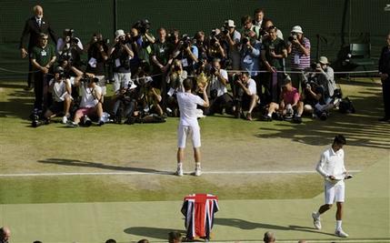 Andy Murray of Britain, center, poses for photographers with the trophy after defeating Novak Djokovic of Serbia, right, in the Men's singles final match at the All England Lawn Tennis Championships in Wimbledon, London, Sunday, July 7, 2013. (AP Photo/Tom Hevezi, Pool)