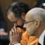 Ariel Castro looks down during court proceedings Friday, July 26, 2013, in Cleveland. Castro, who imprisoned three women in his home, subjecting them to a decade of rapes and beatings, pleaded guilty Friday to 937 counts in a deal to avoid the death penalty. Defense attorney Jaye Schlachet is on the right. (AP Photo/Tony Dejak)