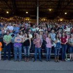 The crowd stands for the national anthem before the start of the Prescott Frontier Days rodeo, Wednesday, July 3, 2013 in Prescott, Ariz. A mile-high city about 90 miles northwest of Phoenix, Prescott remains a modern-day outpost of the pioneer spirit. It's that spirit that will guide officials as they navigate the days ahead and figure out how to honor the elite Hotshot firefighters who died in a nearby wind-driven wildfire that is still burning. (AP Photo/Julie Jacobson)