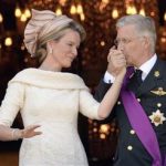 Belgium's King Philippe, right, kisses the hand of Queen Mathilde as they stand on the balcony of the royal palace in Brussels on Sunday, July 21, 2013. Philippe has taken the oath before parliament to become Belgium's seventh king after his father Albert II abdicated as the head of this fractured nation. Earlier Sunday, the 79-year-old Albert signed away his rights as the kingdom's largely ceremonial ruler at the royal palace in the presence of Prime Minister Elio Di Rupo, who holds the political power in this 183-year-old parliamentary democracy. (AP Photo/Geert Vanden Wijngaert)