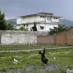 A boy plays with a tennis ball in front of Osama bin Laden's compound in Abbottabad in this May 5, 2011 file picture. REUTERS/Akhtar Soomro/Files