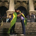 Two demonstrators kiss each other in front of police officers during a protest in central Rio de Janeiro June 27, 2013. REUTERS/Pilar Olivares