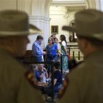 Dozens wait to enter the Senate gallery moments after the Texas State Capitol opened its doors at 7 a.m., in Austin, Texas, Friday, July 12, 2013. The Texas Senate's leader, Lt. Gov. David Dewhurst, has scheduled a vote for Friday on the same restrictions on when, where and how women may obtain abortions in Texas that failed to become law after a Democratic filibuster and raucous protesters were able to run out the clock on an earlier special session. (AP Photo/Tamir Kalifa)