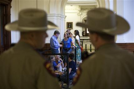 Dozens wait to enter the Senate gallery moments after the Texas State Capitol opened its doors at 7 a.m., in Austin, Texas, Friday, July 12, 2013. The Texas Senate's leader, Lt. Gov. David Dewhurst, has scheduled a vote for Friday on the same restrictions on when, where and how women may obtain abortions in Texas that failed to become law after a Democratic filibuster and raucous protesters were able to run out the clock on an earlier special session. (AP Photo/Tamir Kalifa)