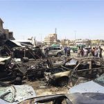 Residents gather at the site of a car bomb attack in the Hurriya District in Baghdad July 29, 2013. Seventeen car bombs exploded in Iraq on Monday, killing at least 55 people in predominantly Shi'ite areas in some of the deadliest violence since Sunni insurgents including al Qaeda stepped up attacks this year. REUTERS/Saad Shalahs