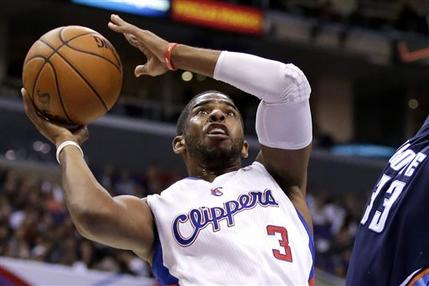 FILE - In this Feb. 27, 2013 file photo, Los Angeles Clippers guard Chris Paul plays against the Charlotte Bobcats during an NBA basketball game in Los Angeles. Paul is staying with the Clippers. The All-Star point guard agreed to a new deal on the first day free agency opened, agent Leon Rose confirms, Monday July 1, 2013. (AP Photo/Chris Carlson)