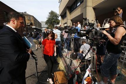 Members of the broadcast media give live reports across from St. Mary's Hospital exclusive Lindo Wing in London, Monday, July 22, 2013. Buckingham Palace officials say Prince William's wife, Kate, has been admitted to the hospital in the early stages of labour.Royal officials said that Kate traveled by car to St. Mary's Hospital in central London. Kate _ also known as the Duchess of Cambridge _ is expected to give birth in the private Lindo Wing of the hospital, where Princess Diana gave birth to William and his younger brother, Prince Harry.The baby will be third in line for the British throne _ behind Prince Charles and William _ and is anticipated eventually to become king or queen. (AP Photo/Lefteris Pitarakis)
