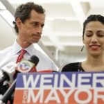 New York mayoral candidate Anthony Weiner glances at his wife, Huma Abedin, as she speaks during a news conference at the Gay Men's Health Crisis headquarters, Tuesday, July 23, 2013, in New York. The former congressman says he's not dropping out of the New York City mayoral race in light of newly revealed explicit online correspondence with a young woman. (AP Photo/Kathy Willens)