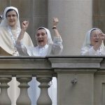 Nuns celebrate and take pictures as Pope Francis arrives to give Angelus noon prayer as they stand on a balcony at Sao Joaquim Palace in Rio de Janeiro, Brazil, Friday, July 26, 2013. Pope Francis is on the fifth day of his trip to Brazil where he will attend the 2013 World Youth Day in Rio. (AP Photo/Luca Zennaro, Pool)