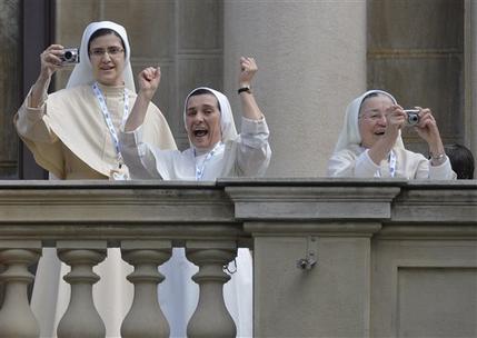 Nuns celebrate and take pictures as Pope Francis arrives to give Angelus noon prayer as they stand on a balcony at Sao Joaquim Palace in Rio de Janeiro, Brazil, Friday, July 26, 2013. Pope Francis is on the fifth day of his trip to Brazil where he will attend the 2013 World Youth Day in Rio. (AP Photo/Luca Zennaro, Pool)