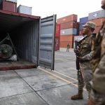 Panama police officers stand guard in front of a container holding a green missile-shaped object seized from the North Korean flagged ship "Chong Chon Gang" at the Manzanillo Container Terminal in Colon City July 17, 2013. REUTERS/Carlos Jasso