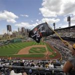Pittsburgh Pirates fan Eddie Fisher of Pittsburgh waves a Jolly Roger as the Pirates come to bat in the bottom of the ninth inning during a baseball game against the New York Mets at PNC Park in Pittsburgh Sunday, July 14, 2013. The Mets won 4-2. After twenty years without a winning season, the Pittsburgh Pirates are putting on a good show in the first half of the 2013 season, and fans in a town so loyal to football and hockey are wondering: Is this finally the time for baseball hope, or is collapse once again just around the corner? (AP Photo/Gene J. Puskar)