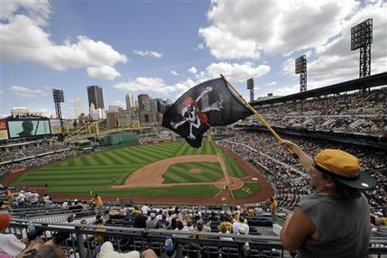 Pittsburgh Pirates fan Eddie Fisher of Pittsburgh waves a Jolly Roger as the Pirates come to bat in the bottom of the ninth inning during a baseball game against the New York Mets at PNC Park in Pittsburgh Sunday, July 14, 2013. The Mets won 4-2. After twenty years without a winning season, the Pittsburgh Pirates are putting on a good show in the first half of the 2013 season, and fans in a town so loyal to football and hockey are wondering: Is this finally the time for baseball hope, or is collapse once again just around the corner? (AP Photo/Gene J. Puskar)