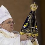 Pope Francis holds up the statue of the Virgin of Aparecida, Brazil's patron saint, during Mass in the Aparecida Basilica in Aparecida, Brazil, Wednesday, July 24, 2013. Reverence for the figure of the Virgin Mary runs particularly deep in Latin America. The Vatican says that Pope Francis personally insisted that a trip to the Aparecida Basilica be added to his Brazilian visit agenda. (AP Photo/Felipe Dana)